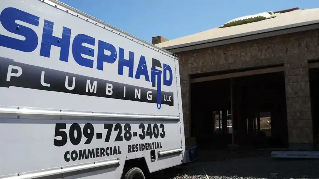 Shephard Plumbing box truck lettered 509-728-3403, Commercial, Residential, parked at a new-build house in Yakima